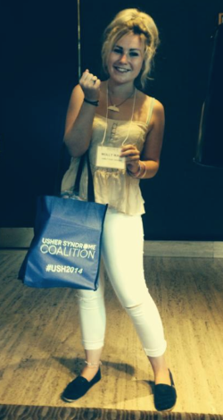 A picture of Molly Watt holding the USH2014 tote and name badge