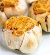 Several roasted garlic cloves with seasoning.