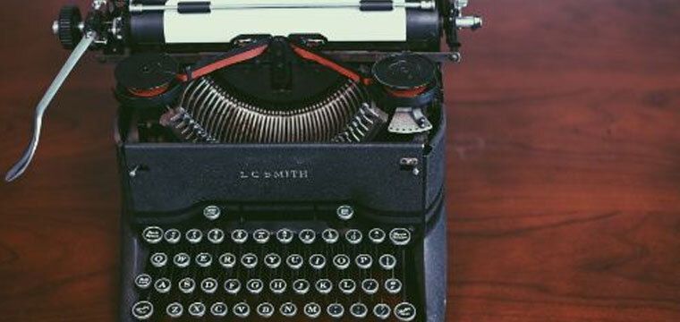 Black typewriter with paper