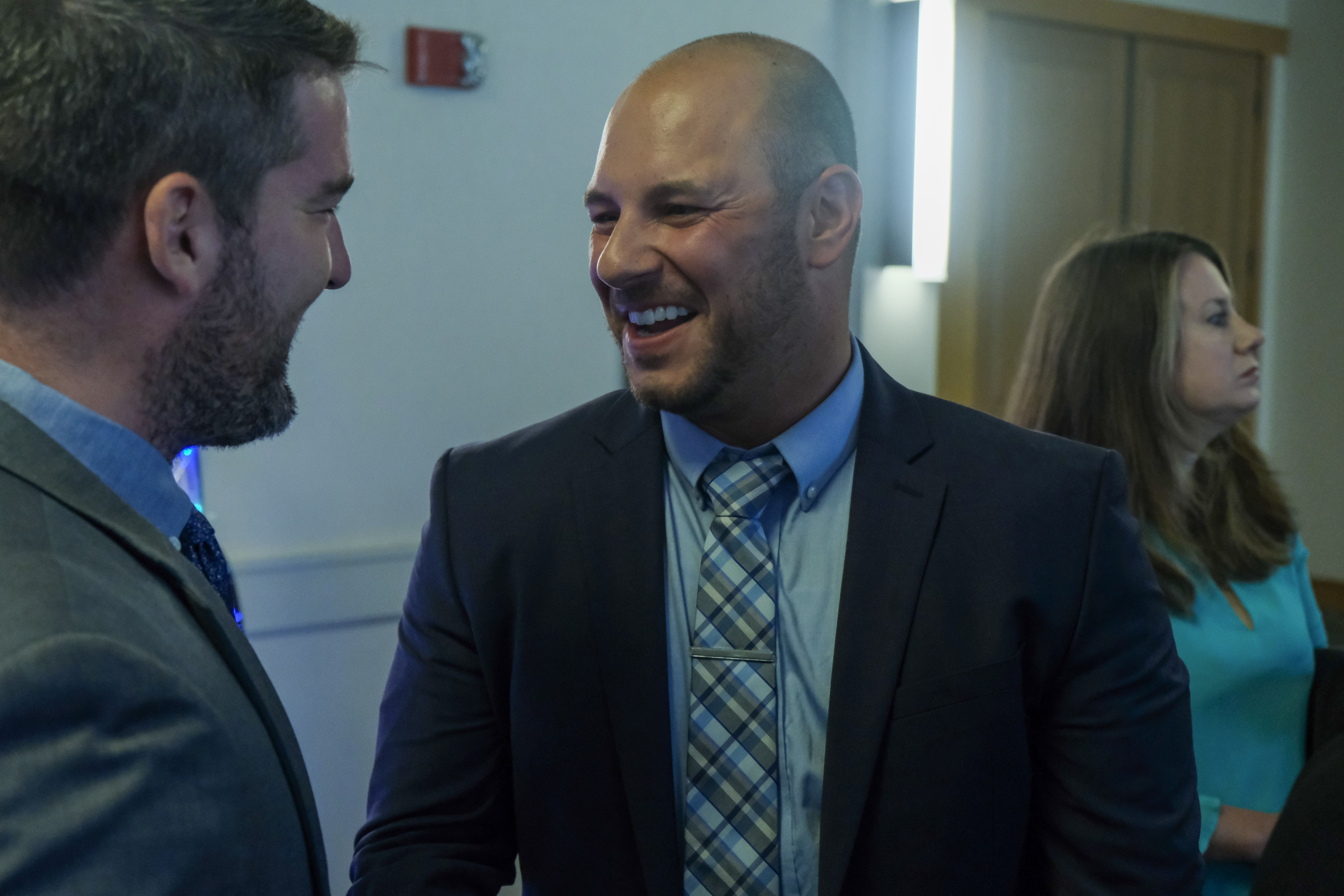 Two smiling men in conversation at a professional gathering, representing the welcoming and collaborative spirit of MEF Chapter support.