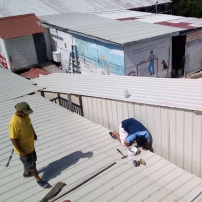 People repairing a roof.