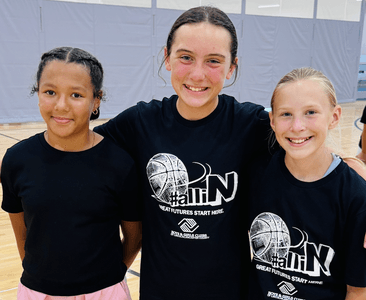Person Looking at a Book from Library Shelf
