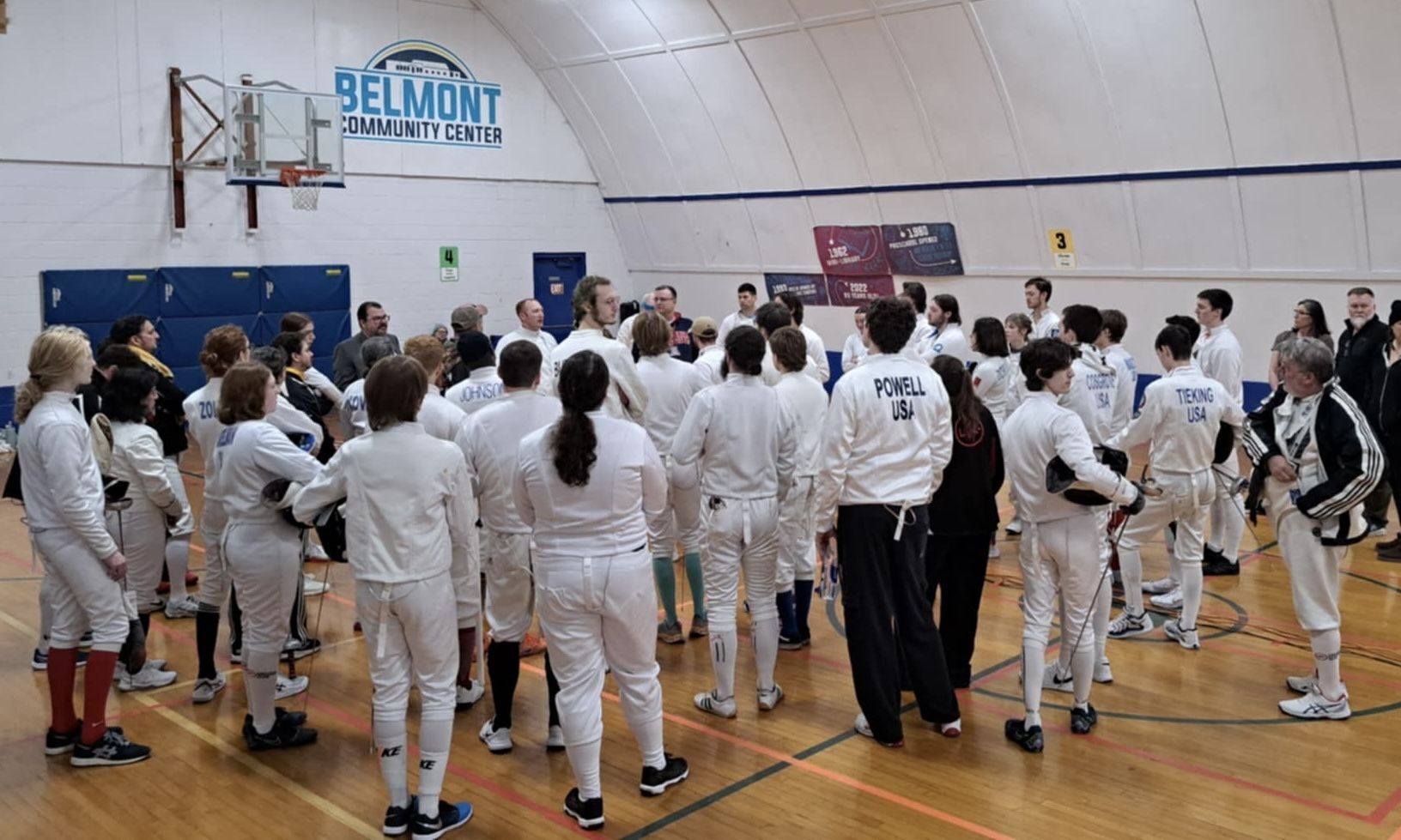 A crowd of fencers gathered