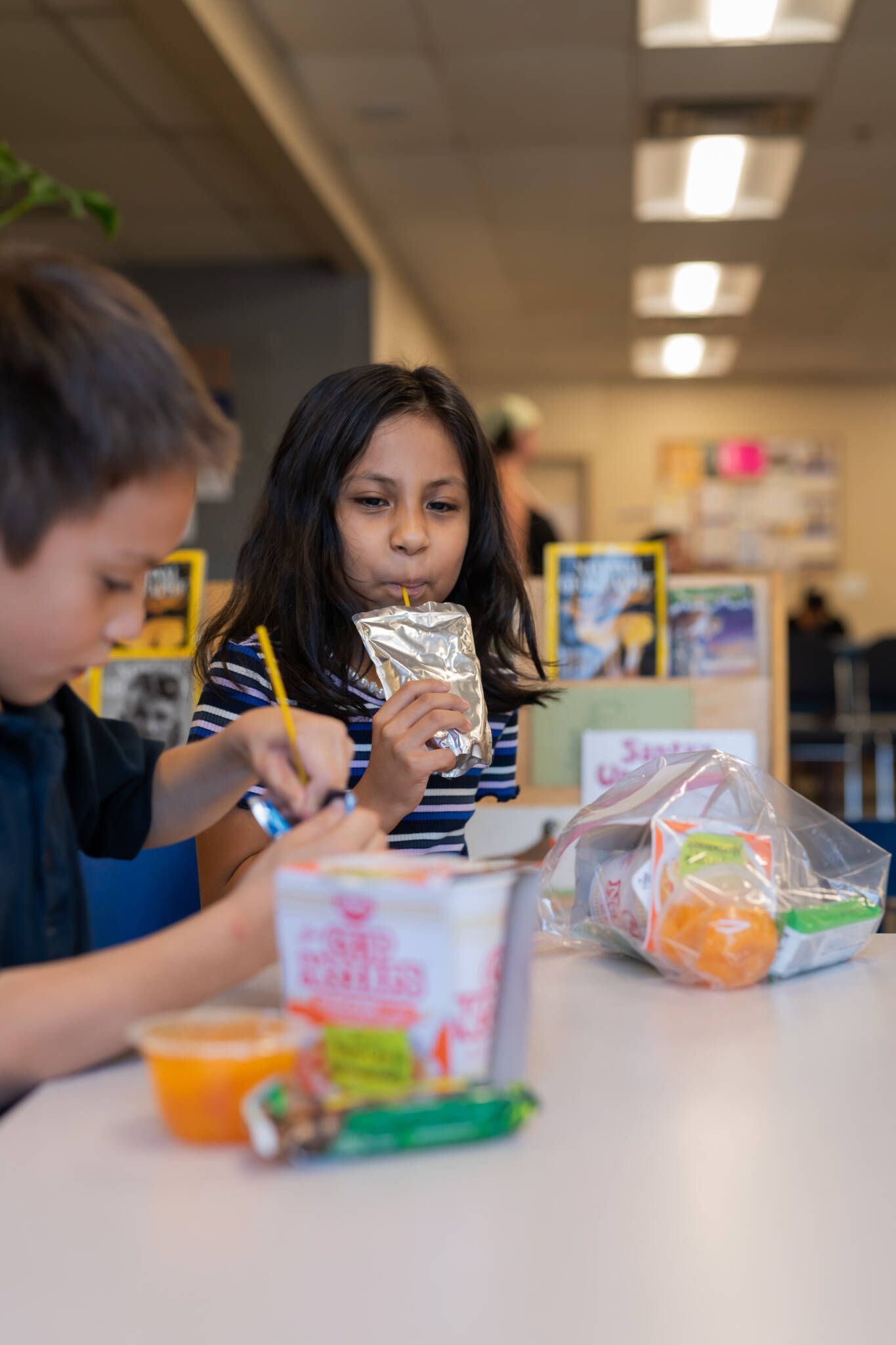 Two children eating lunch.