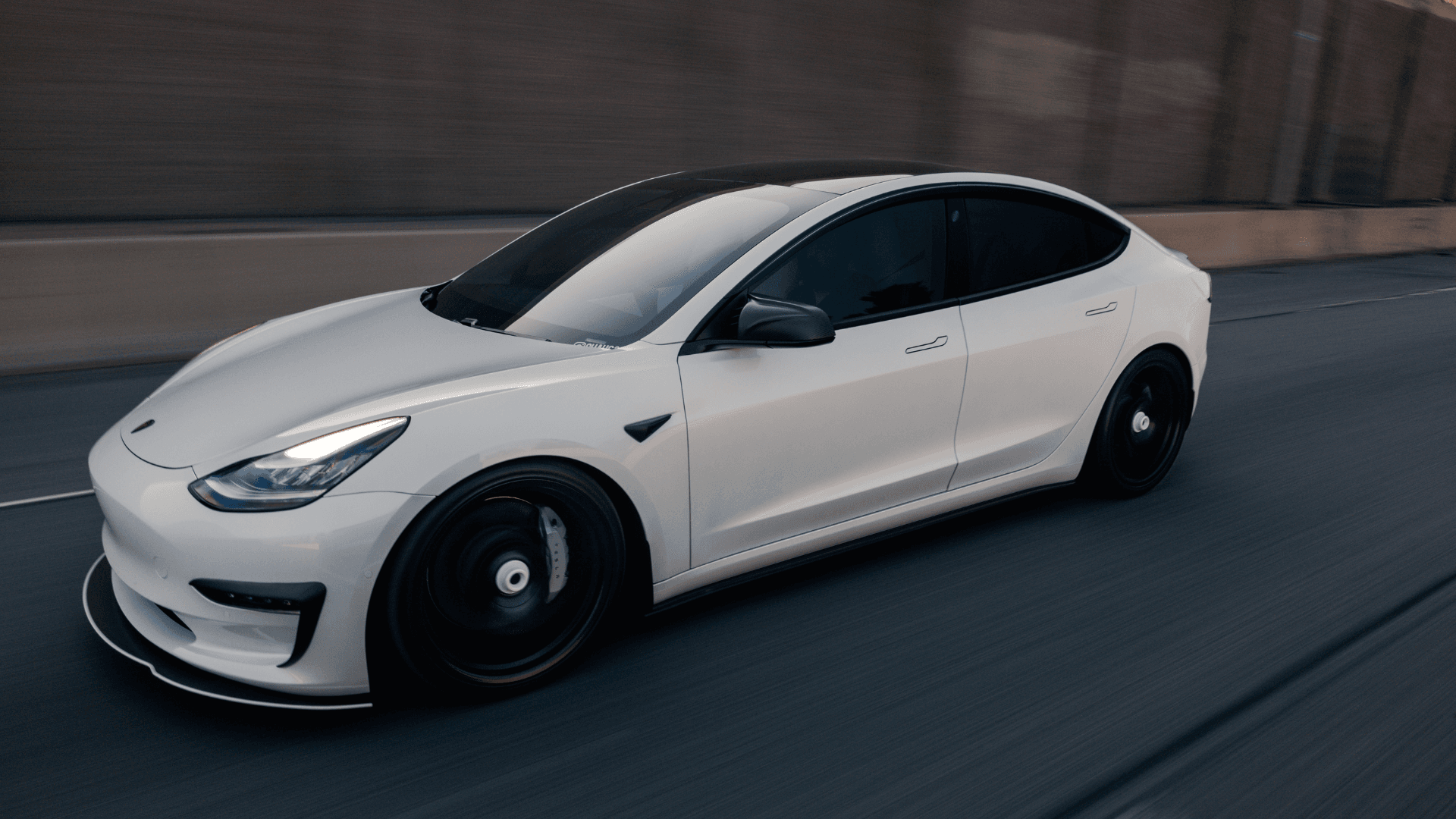 A white Tesla in motion