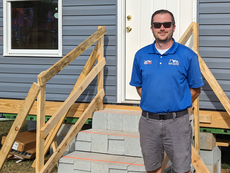 Dolly's Roofing Customer Service Representative Mark Hayter visiting the 2023 Homecoming Build