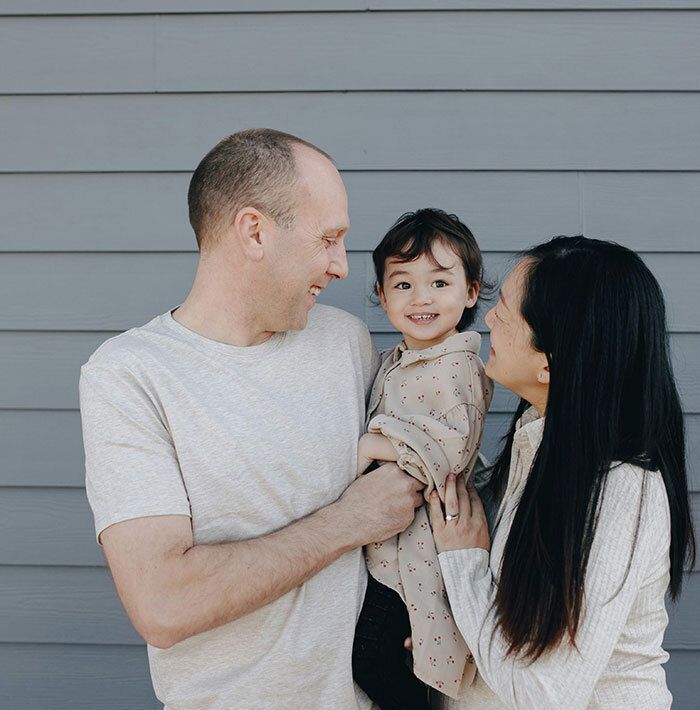 Parents Smiling at Toddler