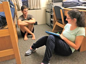 Two students chat in dorm room