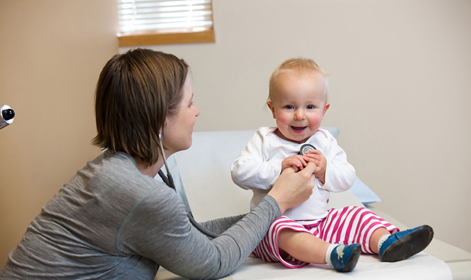 Doctor examining young child