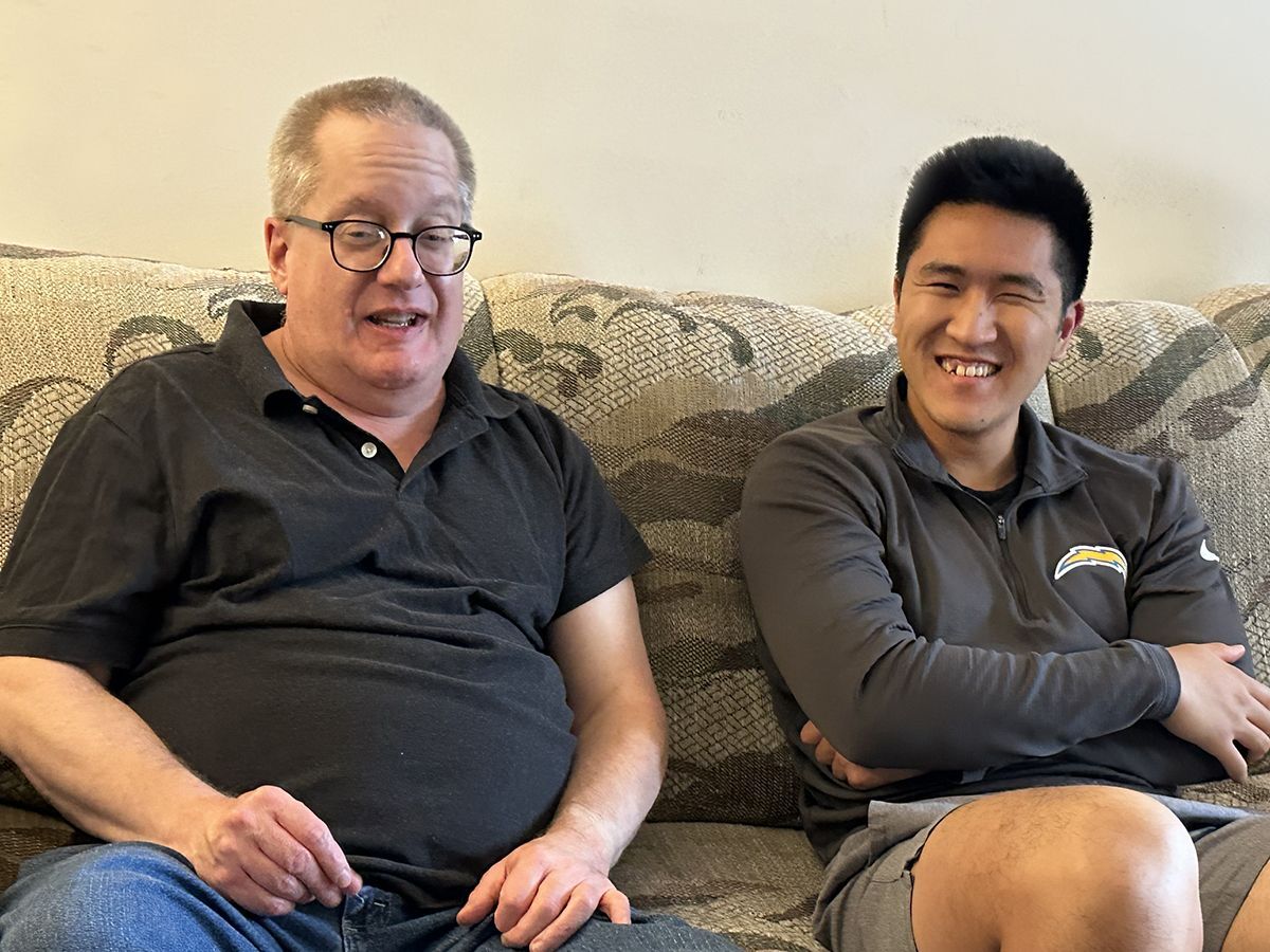Friendly Visiting match David and Phillip sitting on the couch.