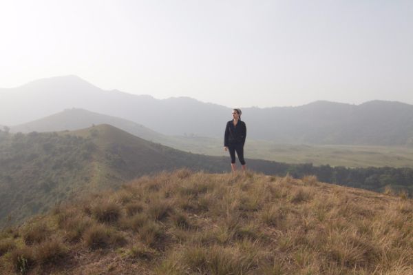 Photo of Rachel in Cameroon overlooking mountains and hillsides