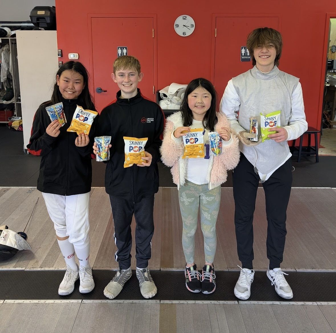 Youth foil fencing winners pose with their prizes