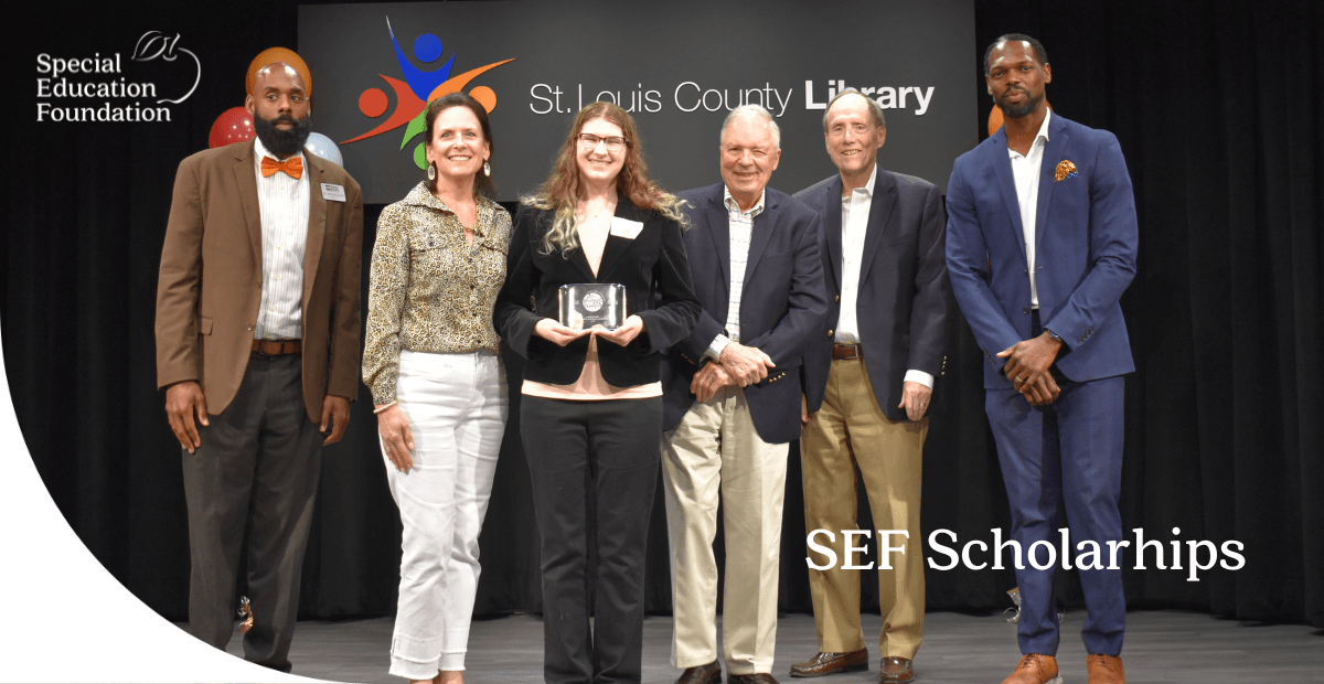 girl on stage holding an award with a few adults