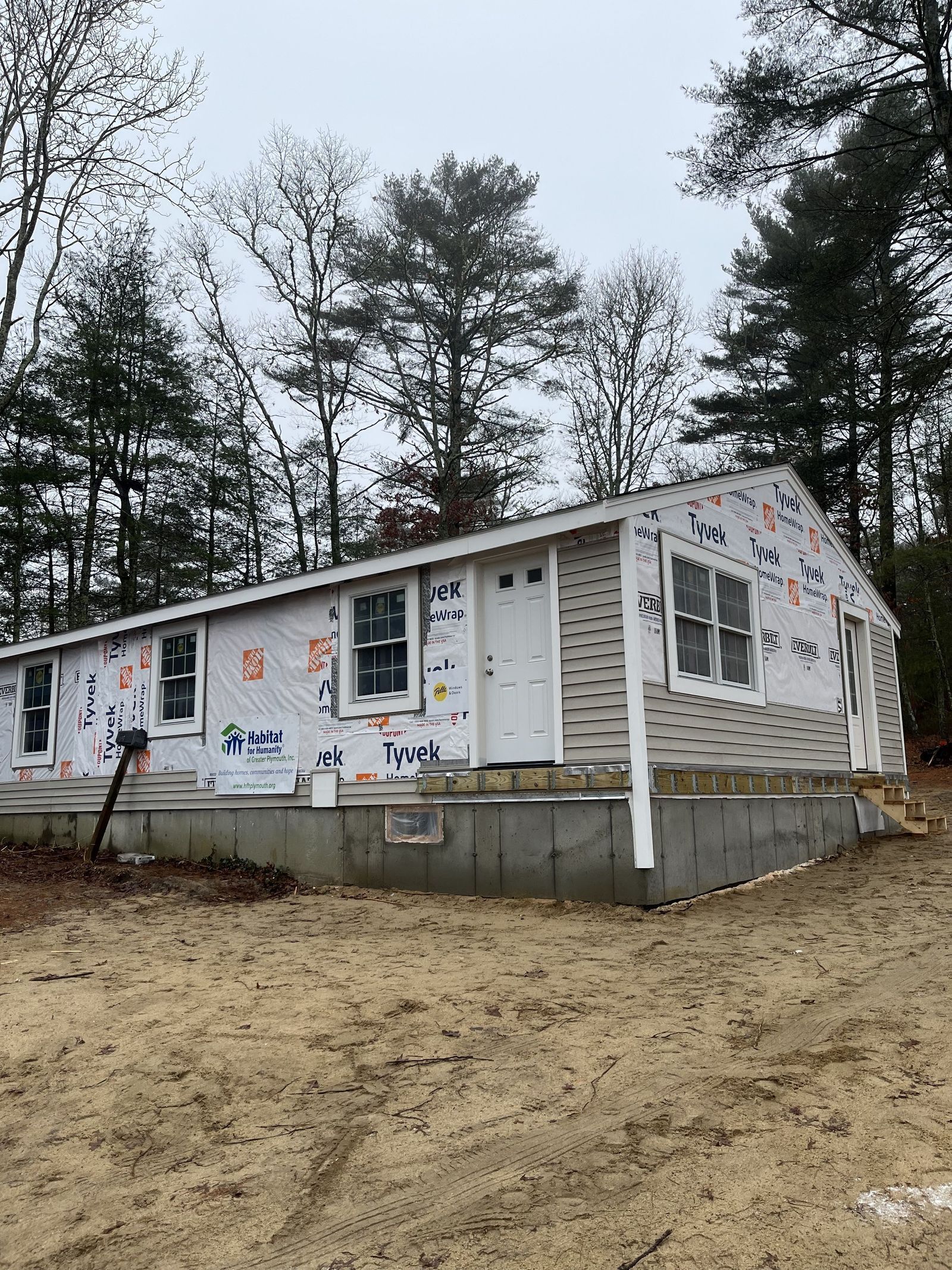 Photo of full house exterior showing some siding installed