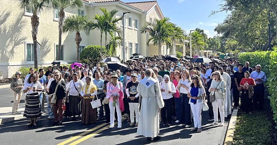 Rosary procession pauses outside of the cathedral's Family Life Center