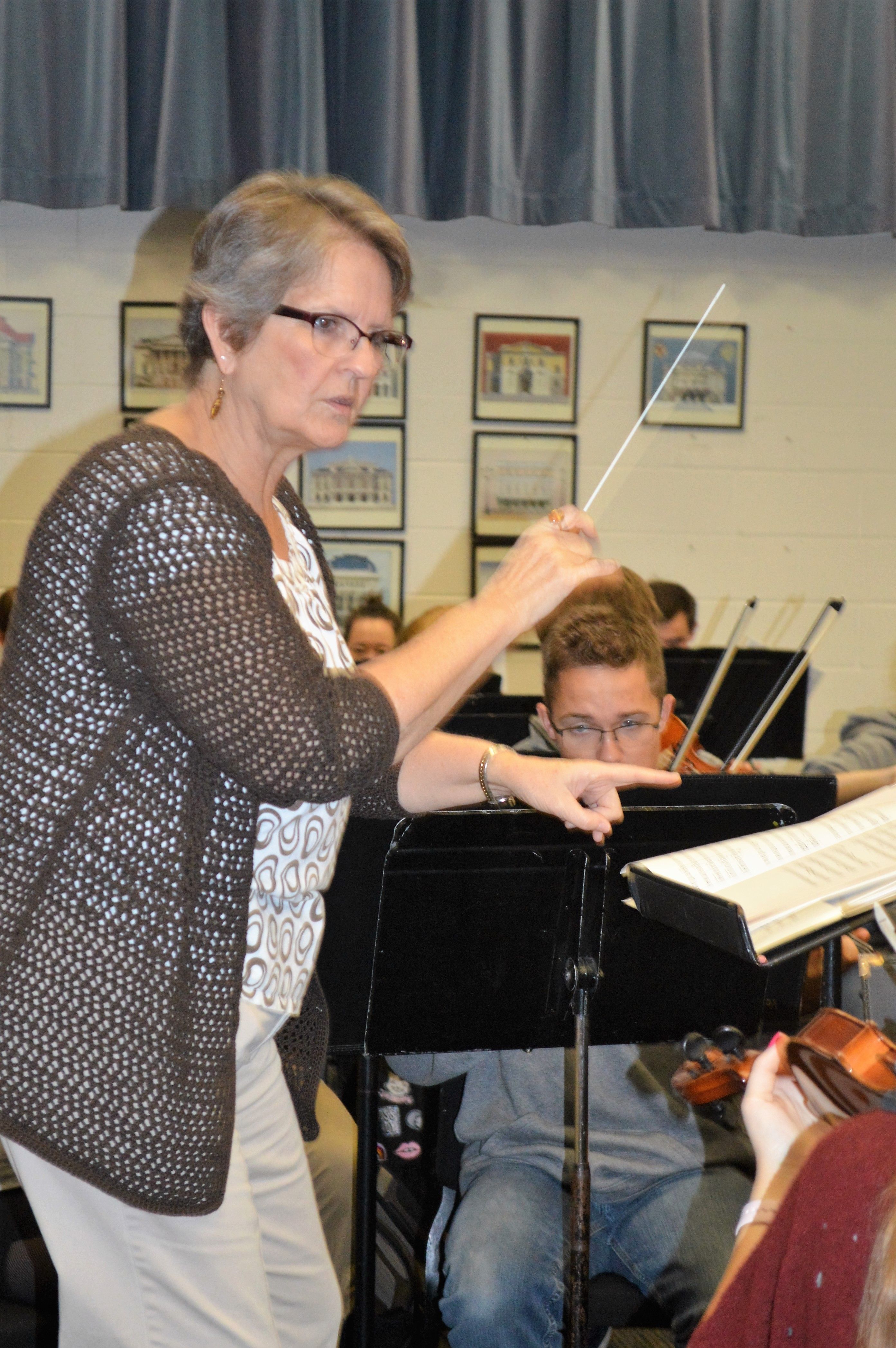 Mary Hillyard conducting High School orchestra