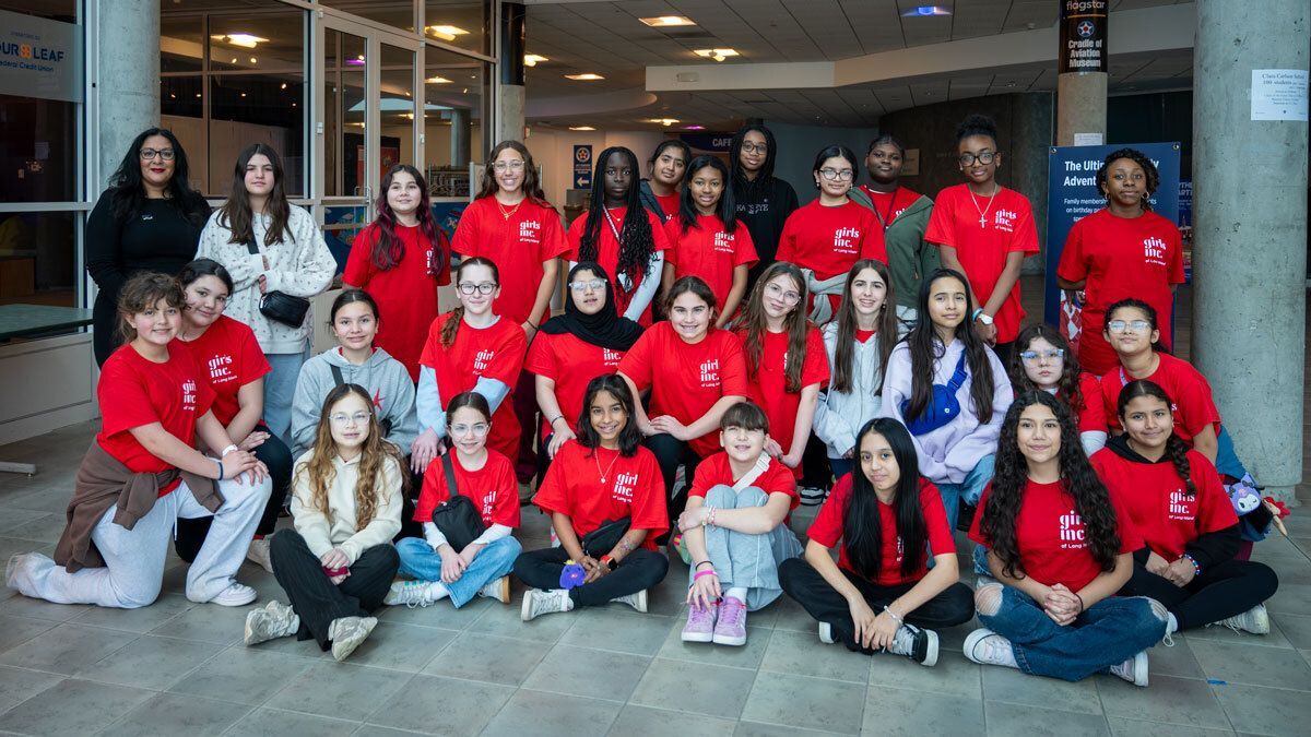 Karen Ali, Chief Operating Officer of JFK Millennium Partners, speaking to a  group of young women at the Cradle of Aviation Museum about careers in aviation and leadership.