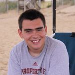 Boy in gray shirt smiling at camera