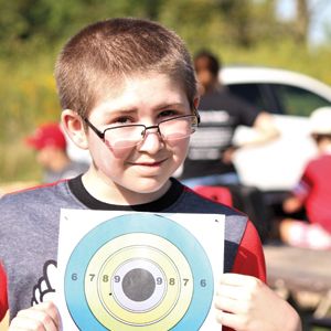 Young boy with paper target