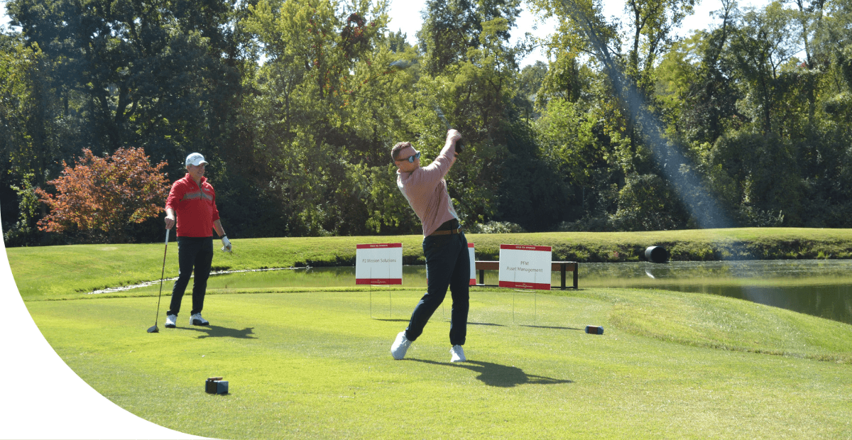 man swinging a golf club on a golf course