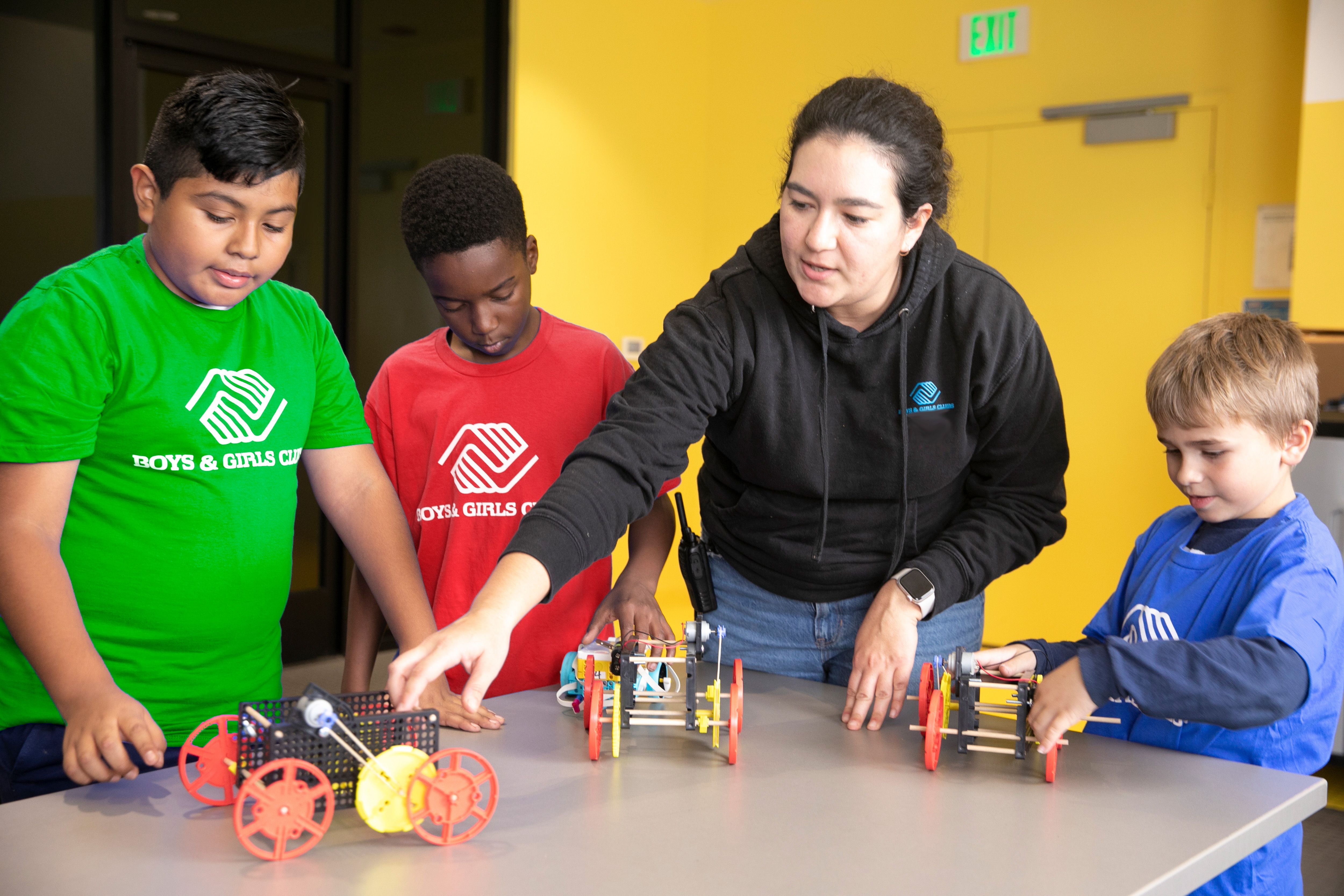 Adult mentors help students learn about math and science through hands-on projects building robots.