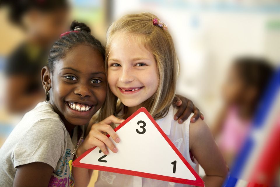 Two young girls smiling