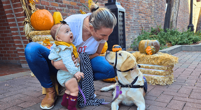 Tia and Hearing Dog Dancer connecting outside