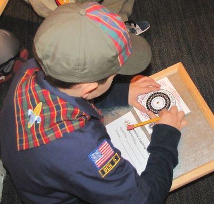 Webelo scout learns about ciphers with the cipher challenge at the National Cryptologic Museum