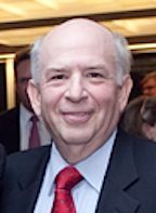 Louis Morrell, Treasurer. An image of a man who in his 60's and he is wearing a suit with a tie. He is also smiling for the picture.
