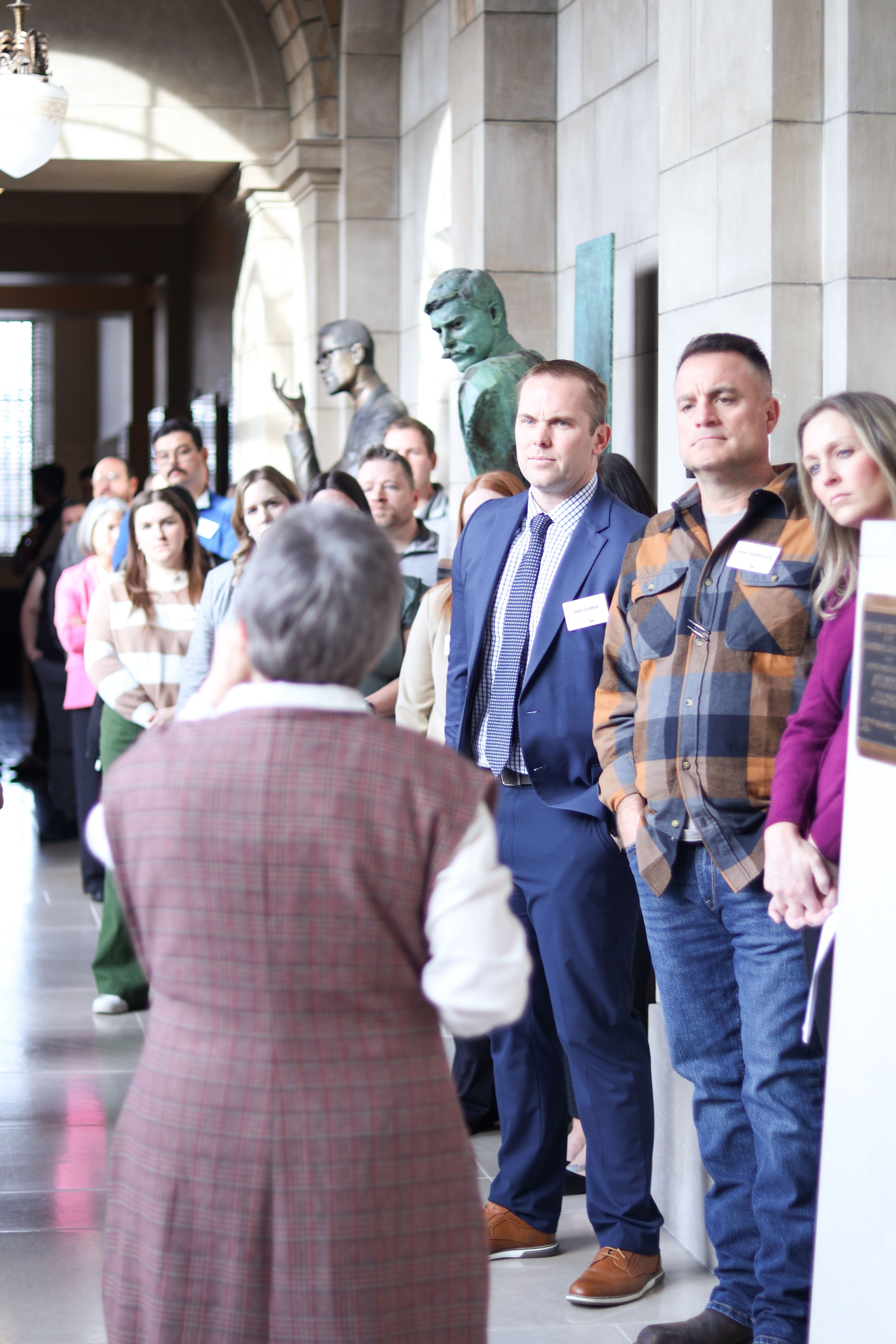 Members of the Executive program watch a tour guide in the Lincoln Capitol