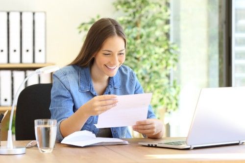 young woman reading mail