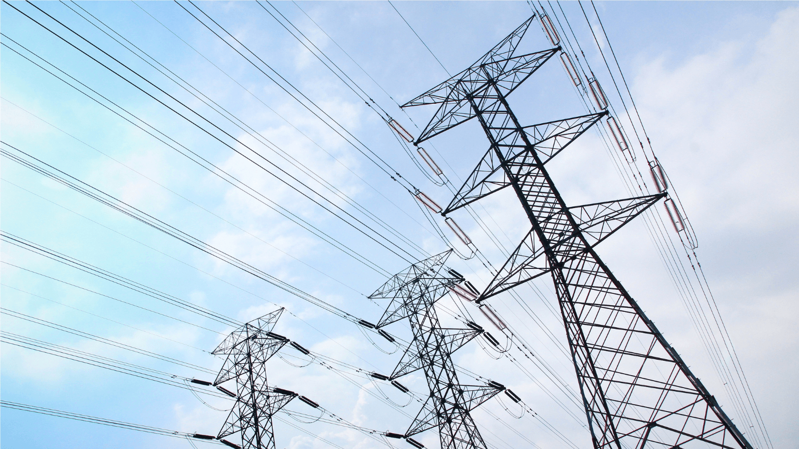 connected power lines against a blue sky 