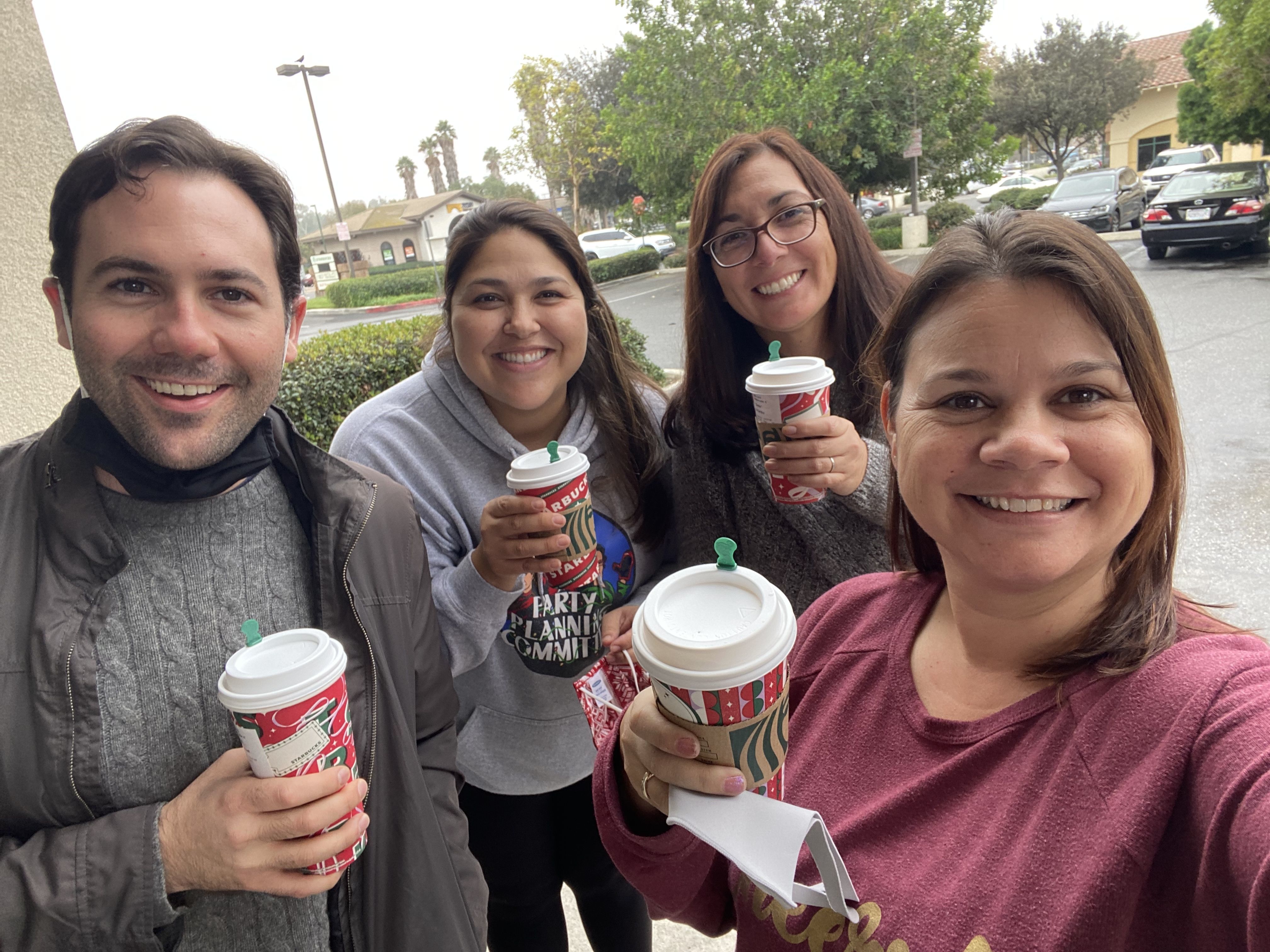 Four of our team members grabbing a coffee, taking a selfie.