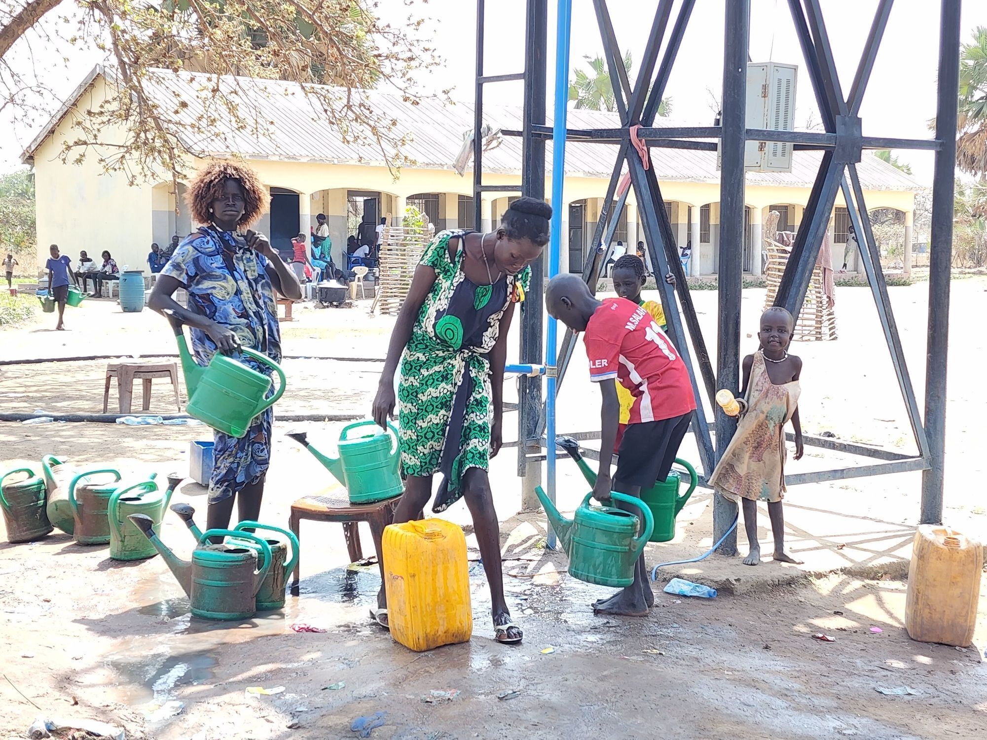 Community Members Filling Buckets