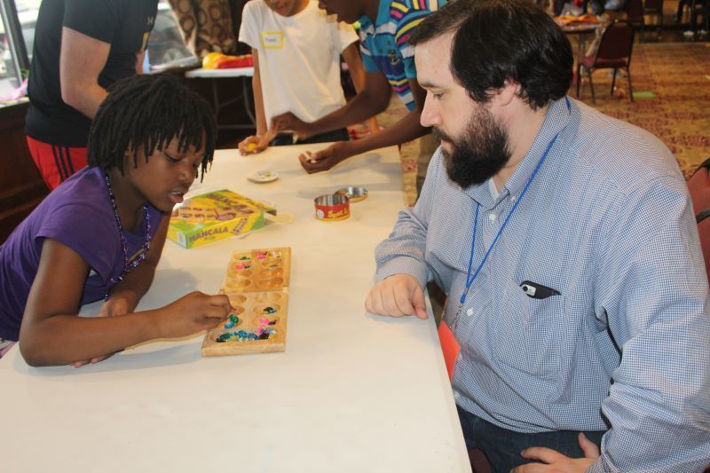 Jason Wucinski plays a game with one of the preteens.