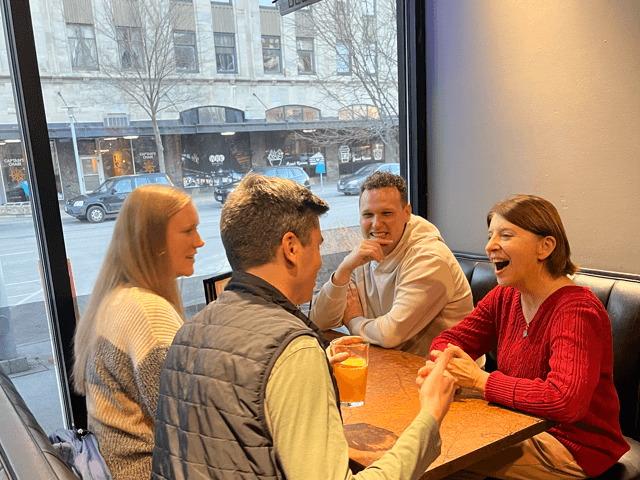 This is an image of a mentor talking to Intern Foundry students.