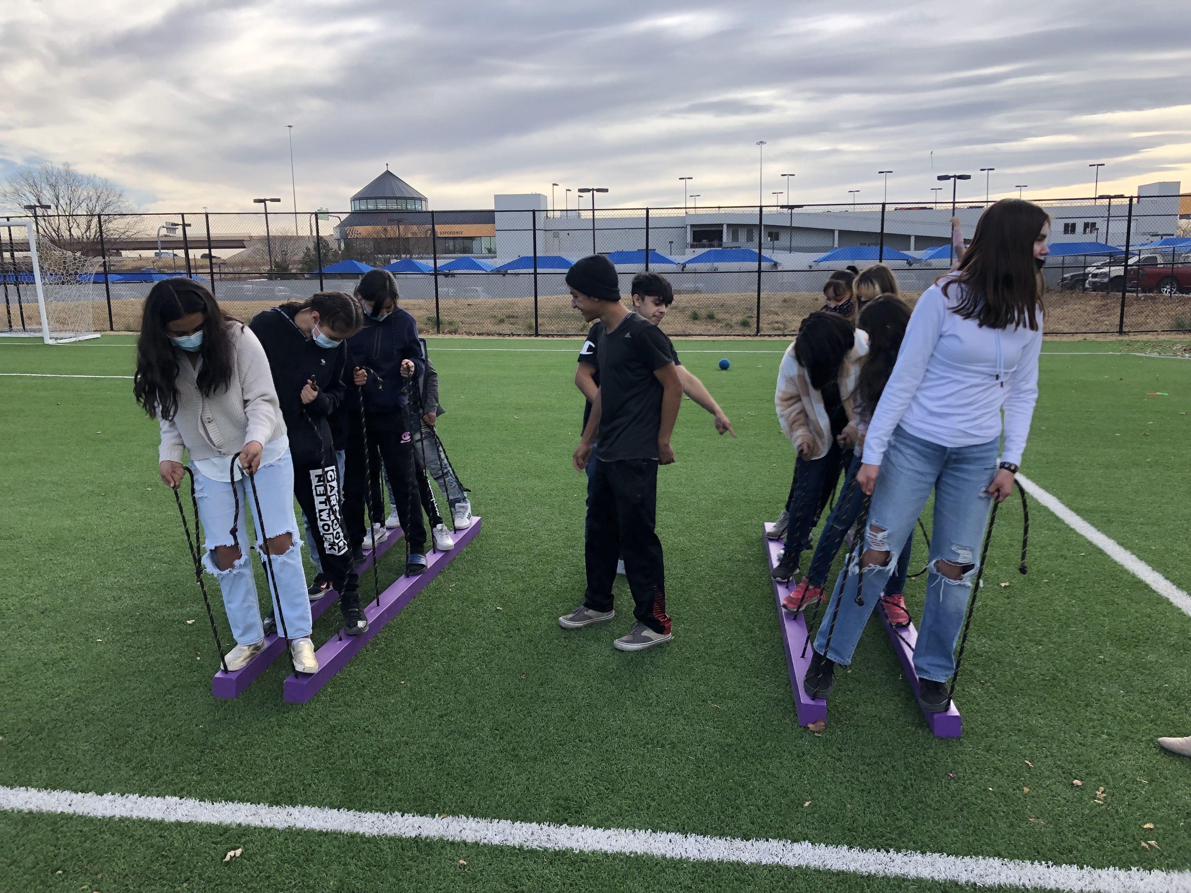 Middle school students participate in a team-building activity on the field, supported by a Marchi Mini Grant"