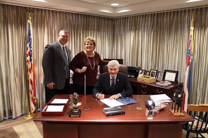 Danay and Gil Trest with Mississippi Governor Phil Bryant in his office as he signs a proclamation for Usher Syndrome Awareness Day.