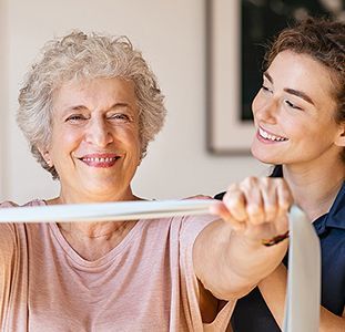 Woman and her physical therapist doing a strength exercise with a band