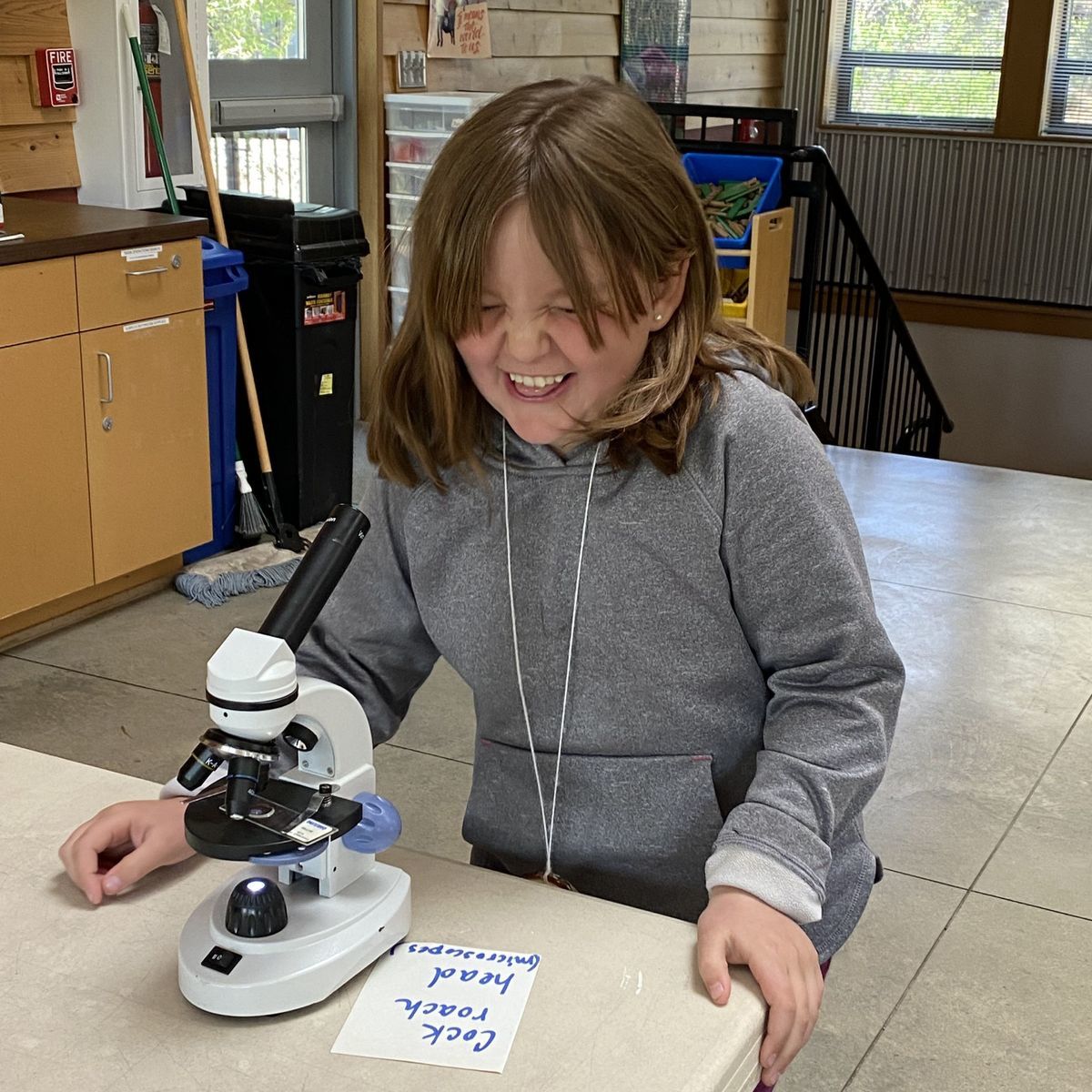 A student making a funny face after looking at a cockroach head under the stereoscope.