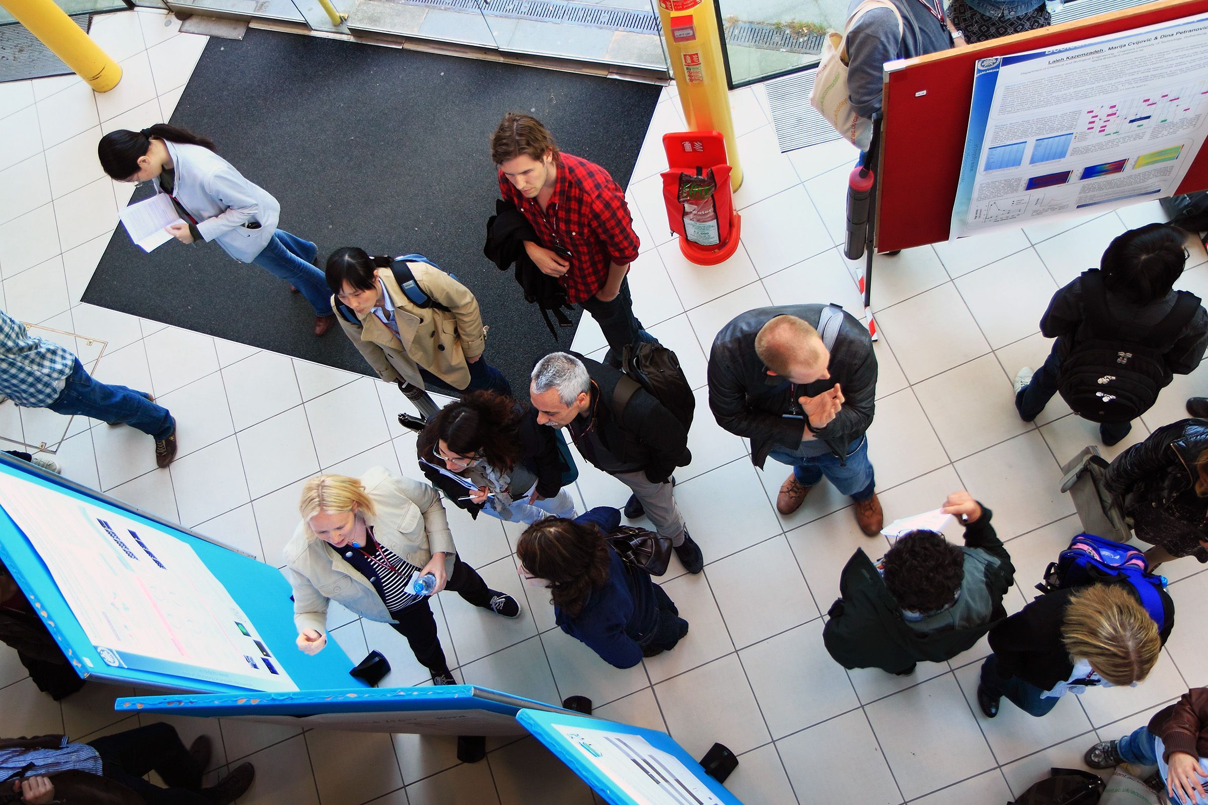 Overhead shot of people looking at scientific posters