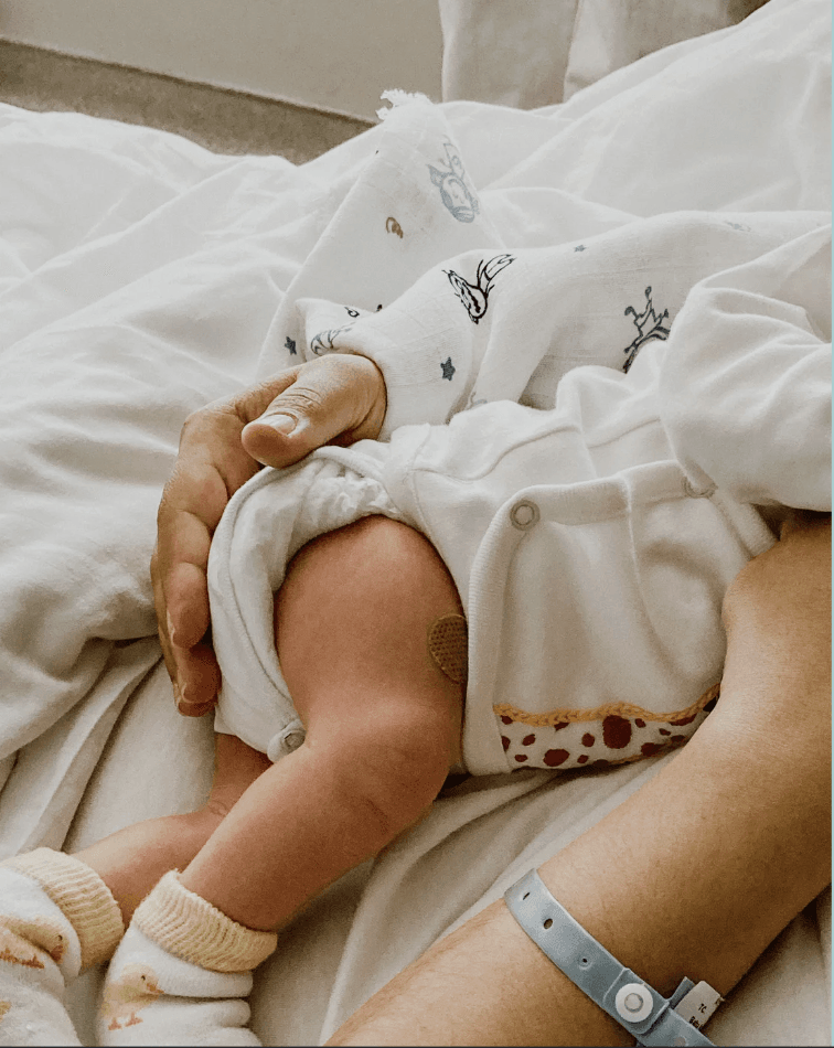 Image of a mother holding her newborn on her lap