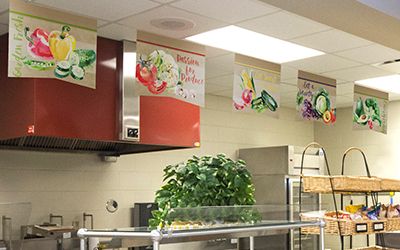 5 food banners hanging in school serving line, watercolor style