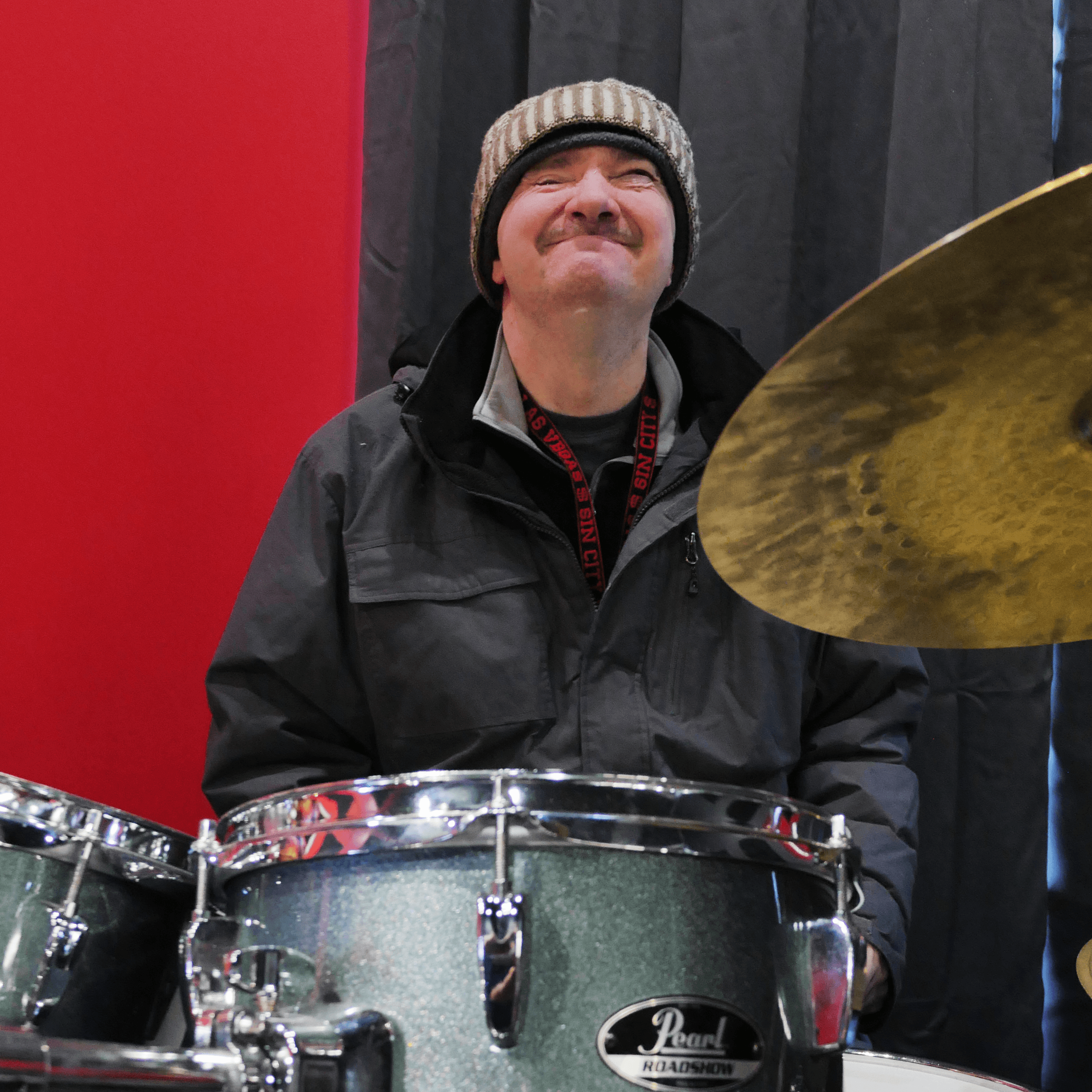 Chris has a wide smile as he rocks out on the drums!