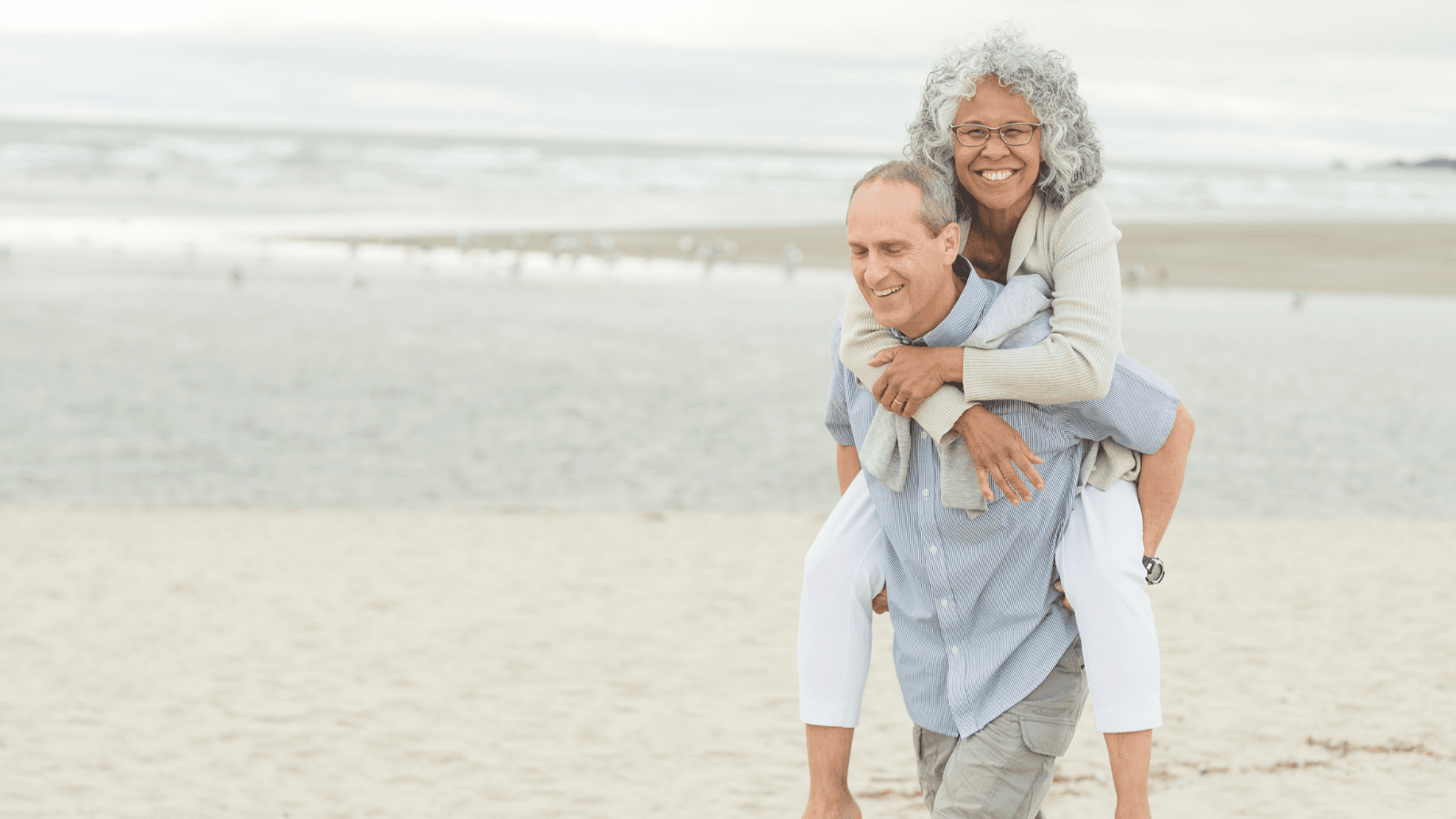 Smiling older couple working with financial planner