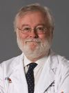 Photo of Dr. Dennis Black wearing a white lab coat
