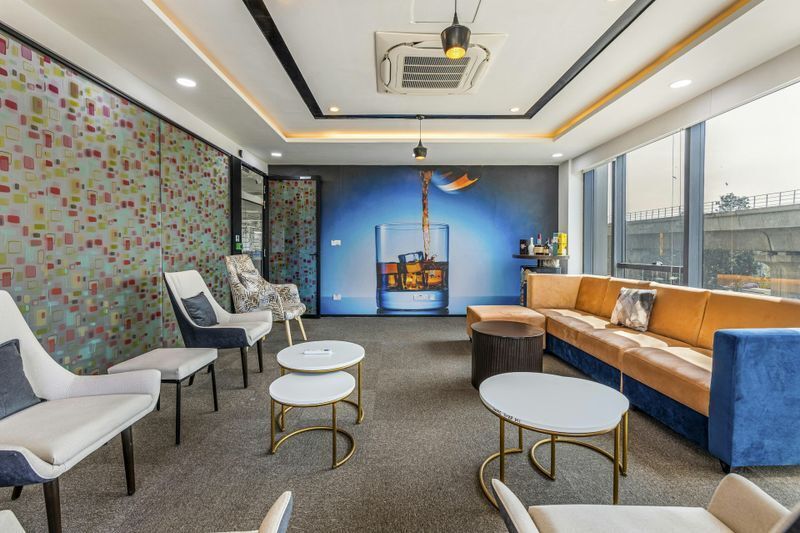 High-quality office wall graphics featuring a vibrant beverage mural in a corporate lounge, demonstrating durable office branding applications.