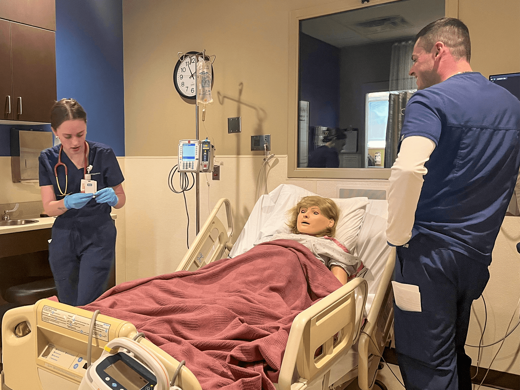 nursing students smiling while in simulation labs