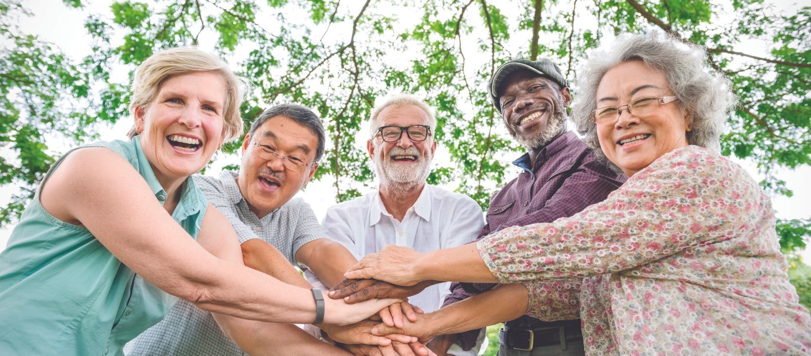 group of older adults with hands together