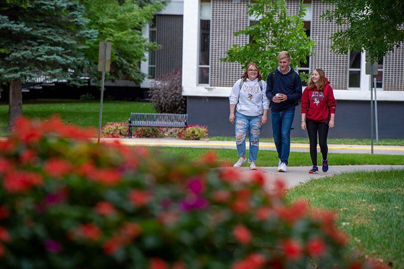 Students walking outside the Student Center engaging in conversation